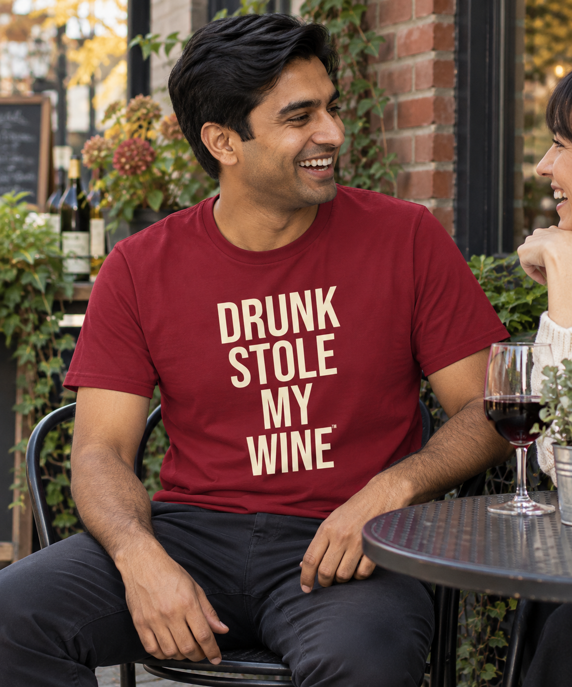 Man wearing a red Drunk Stole My Wine shirt outside a wine bar