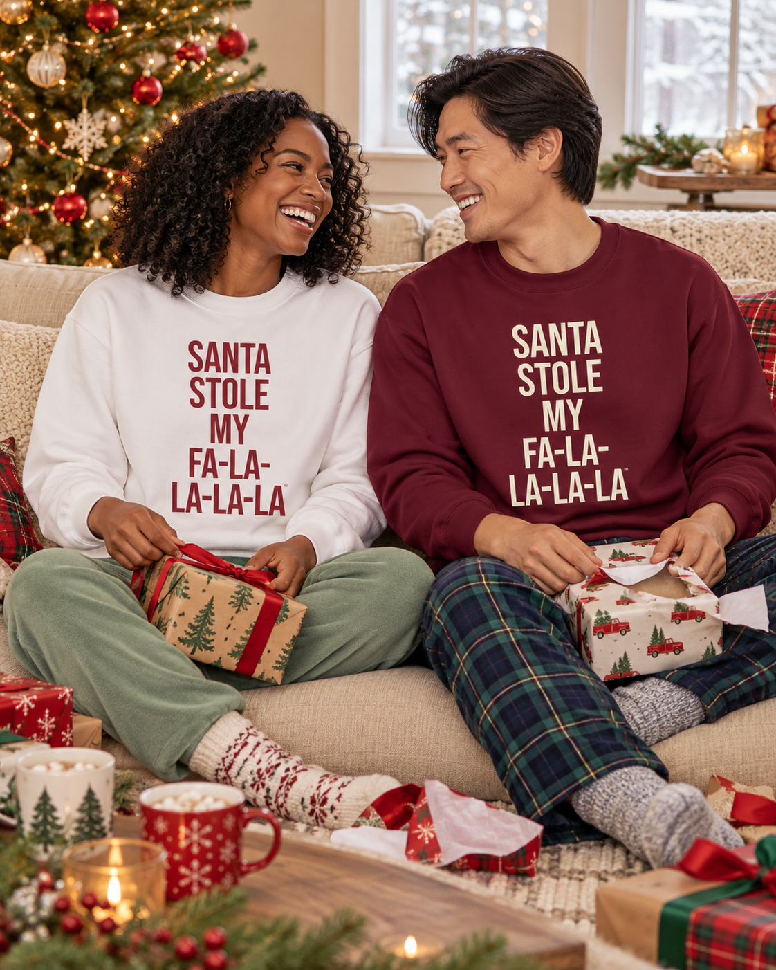 Two people wearing white and burgundy Santa Stole My Fa-La-La-La-La sweatshirts with holiday gifts