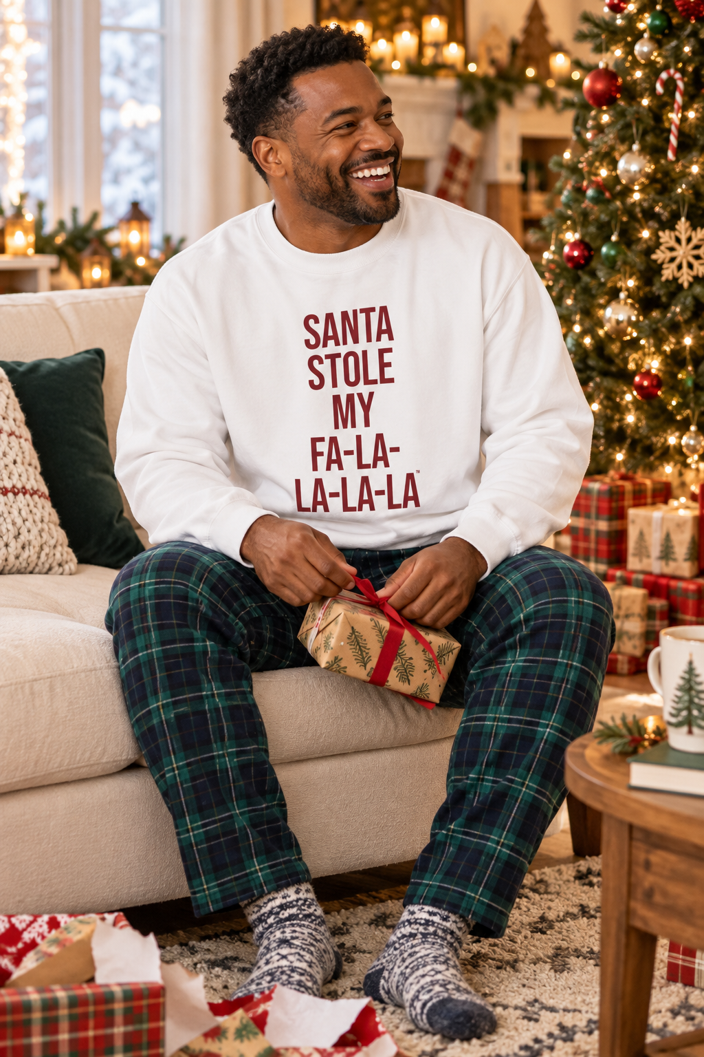 Man wearing a white Santa Stole My Fa-La-La-La-La sweatshirt while holding a gift