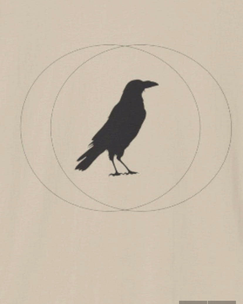 A minimalist graphic print featuring a solid black crow silhouette standing inside two intersecting thin circles, centered on a warm beige background.