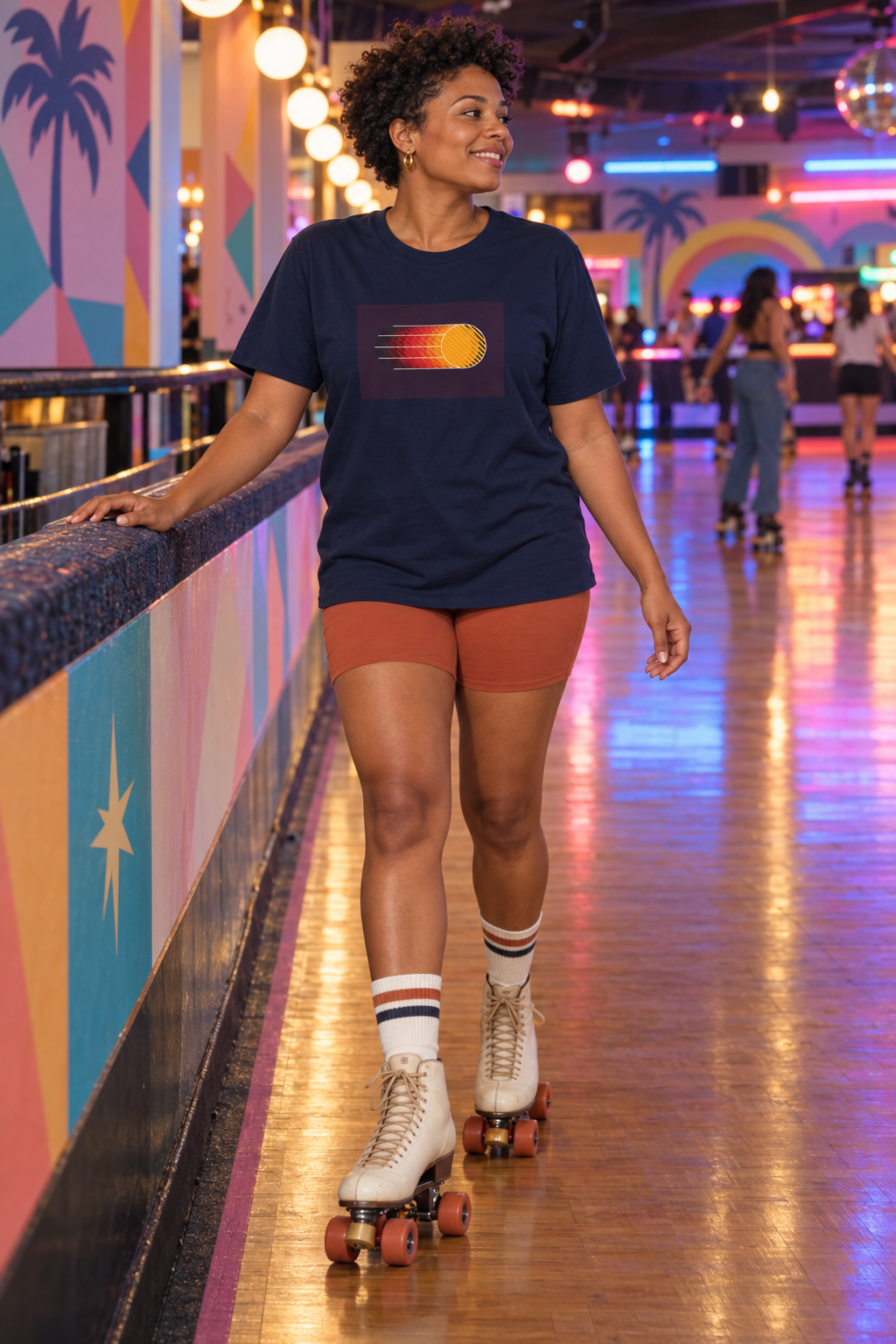 Woman wearing a navy Retro Sunset shirt at a roller rink