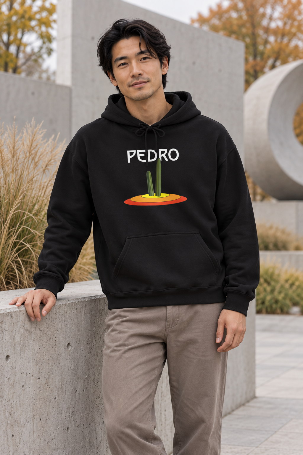 Man wearing a black Pedro Cactus hoodie outdoors