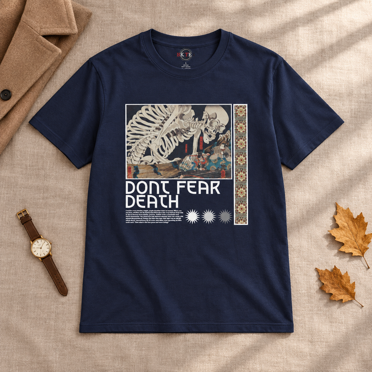 Navy Don't Fear Death skeleton shirt laid flat with autumn leaves