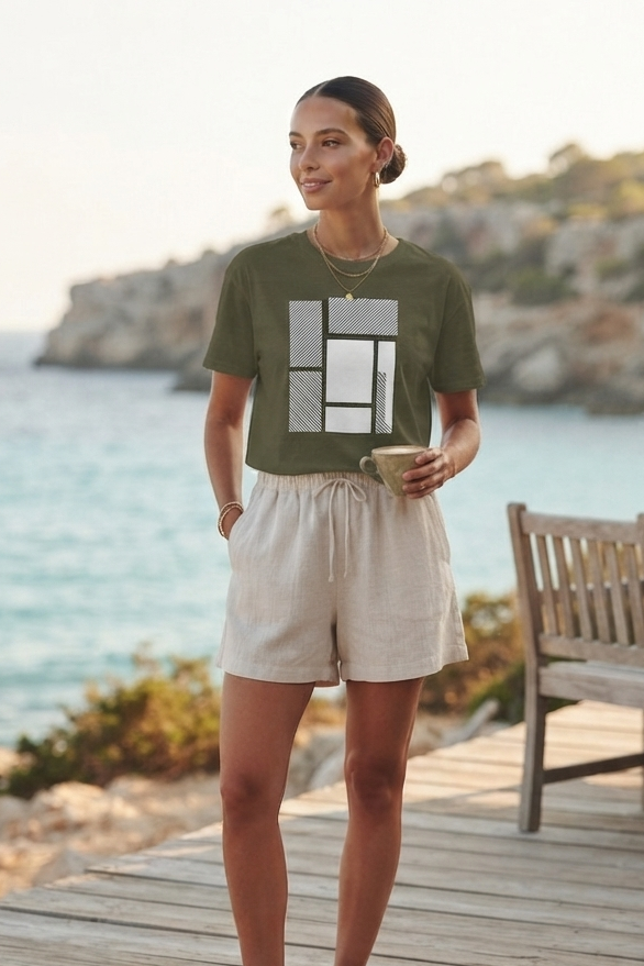 Woman wearing a green Minimalist Abstract Geometric shirt by the waterfront