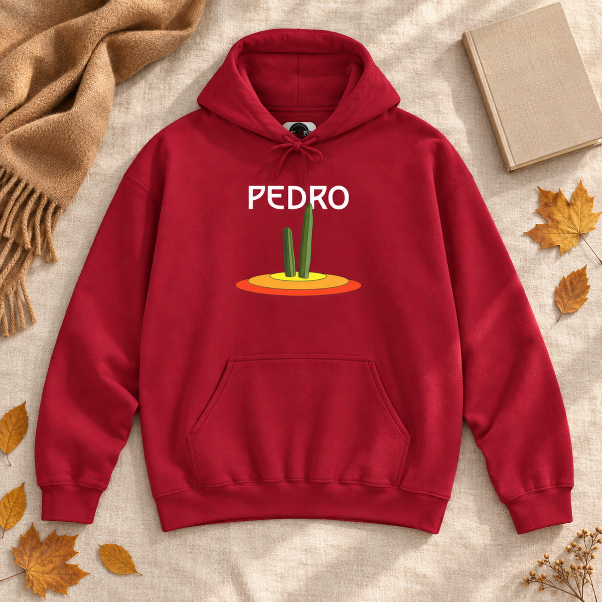 Red Pedro Cactus hoodie laid flat with autumn accessories