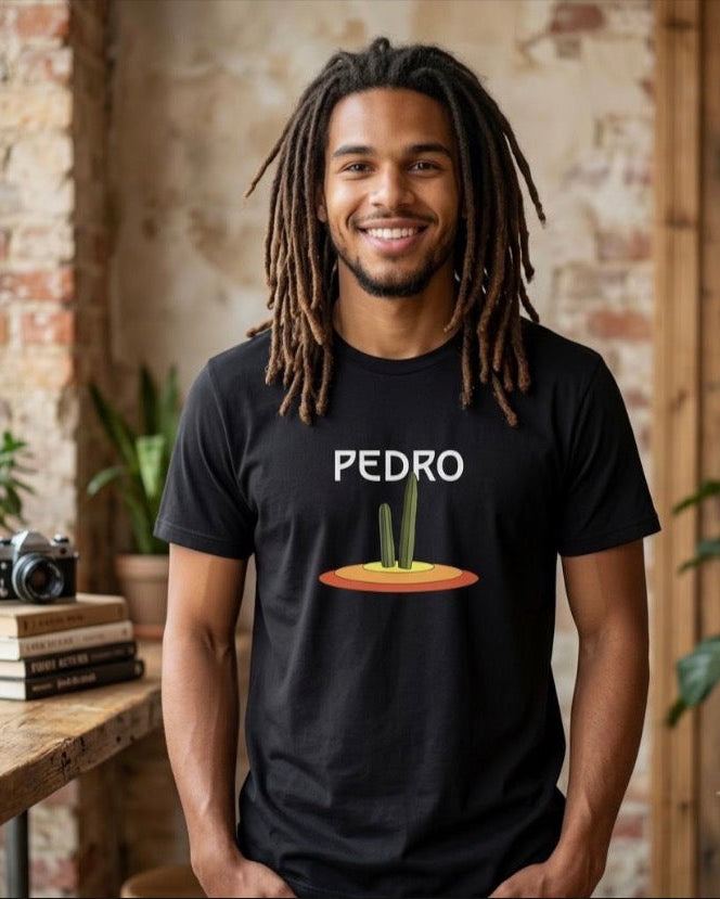Man wearing a black Pedro Cactus shirt indoors